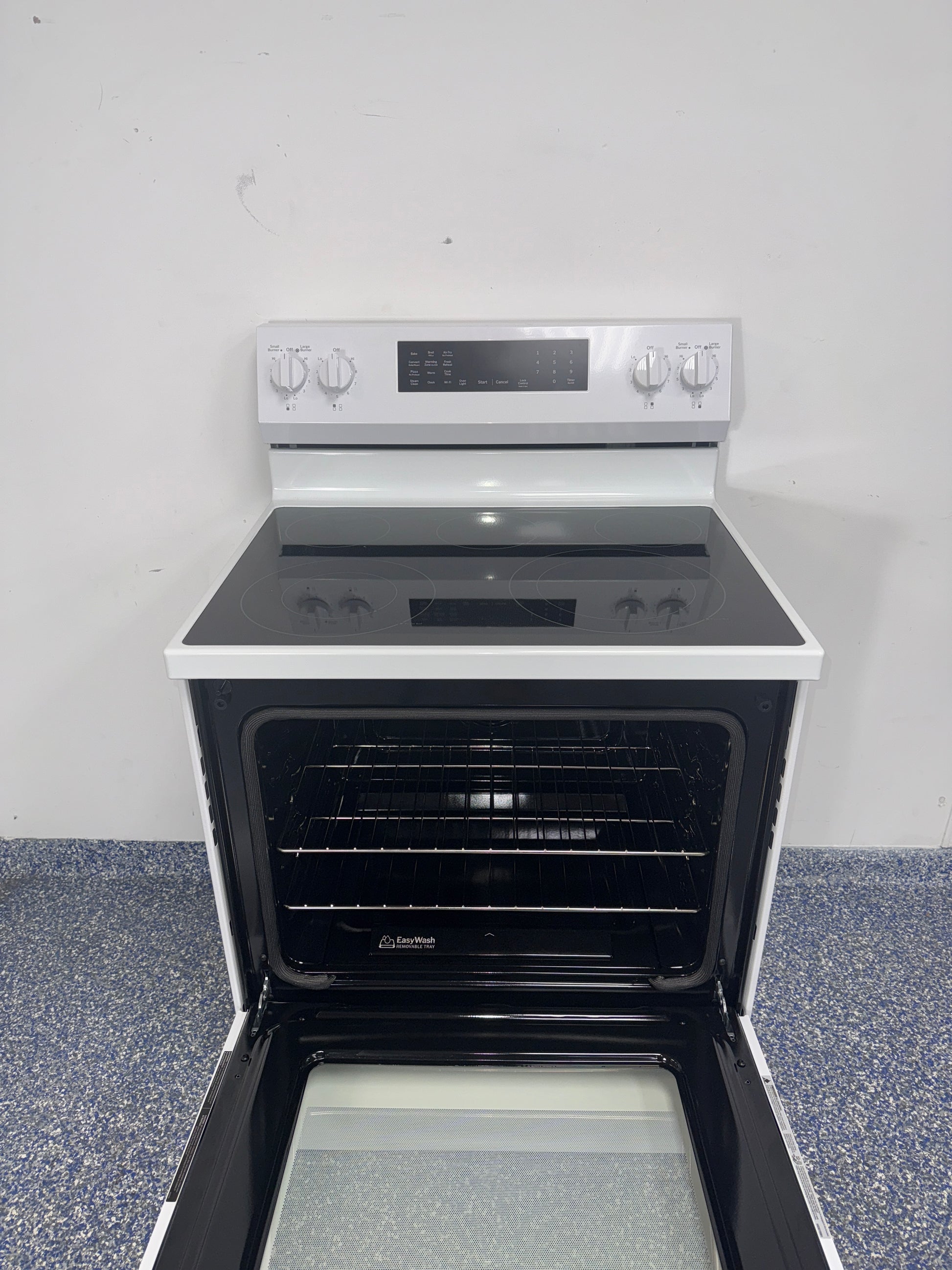 GE GRF600AV2WW electric range smooth cooktop view in Overland Park KS