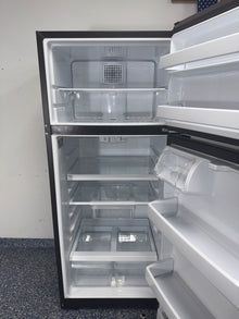 Front view of the GE GTS18HYNRFS top freezer refrigerator with stainless steel finish in a Kansas City kitchen.