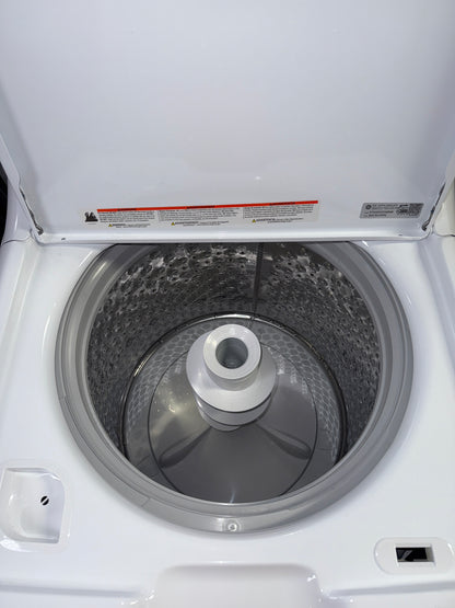 A front view of the GE GTW485ASW0WB washer, highlighting its Auto Sensing technology, ready for installation in a Kansas City laundry room.