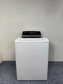 A frontal image of the GE GTW585BSVWS top-load washer in white, showcasing its control panel and clean design.