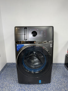 A full frontal image of the GE Profile PFQ97HSPVDS all-in-one washer dryer, showcasing its Carbon Graphite finish and modern design. On sale at Appliance Shark - Scratch & Dent store | Kansas City.