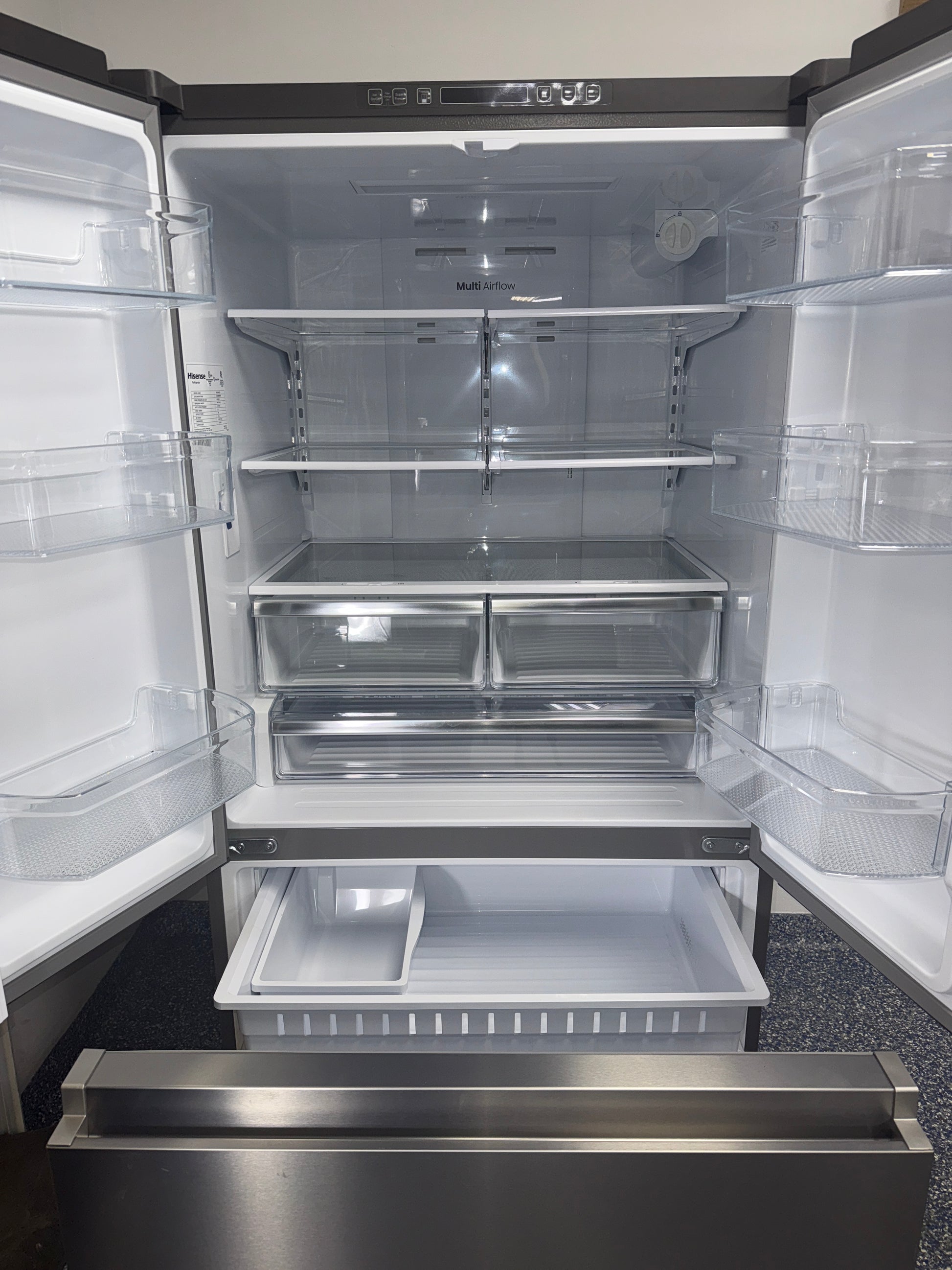 Interior view of the HISENSE HRF266N6CSE1 refrigerator showing adjustable glass shelves and wide storage for Overland Park, KS homes.
