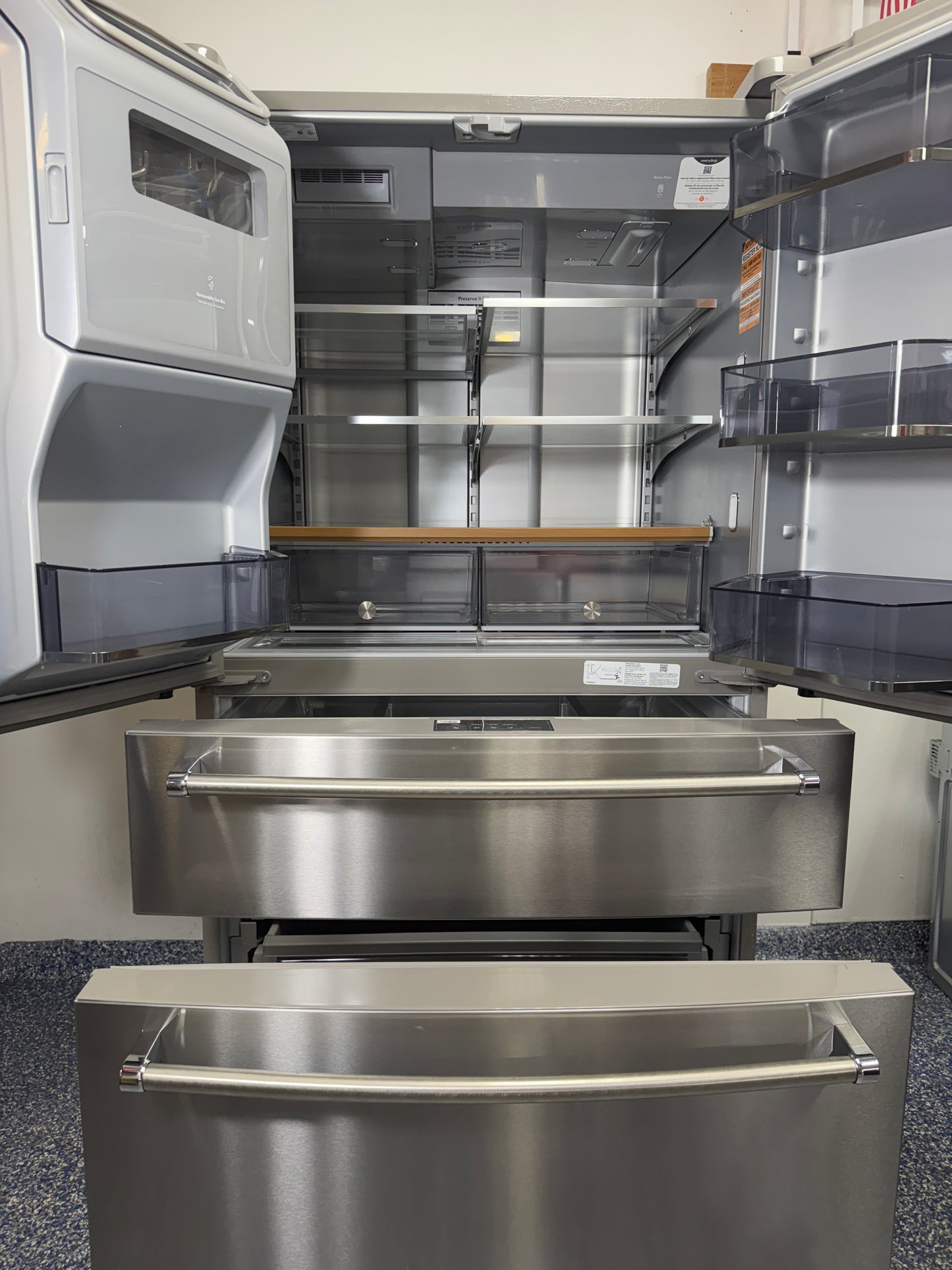 View of the KitchenAid KRMF536RPS refrigerator with all five doors open, showing the spacious interior, shelving, and organizational features. On sale at Appliance Shark - Scratch & Dent store | Kansas City.