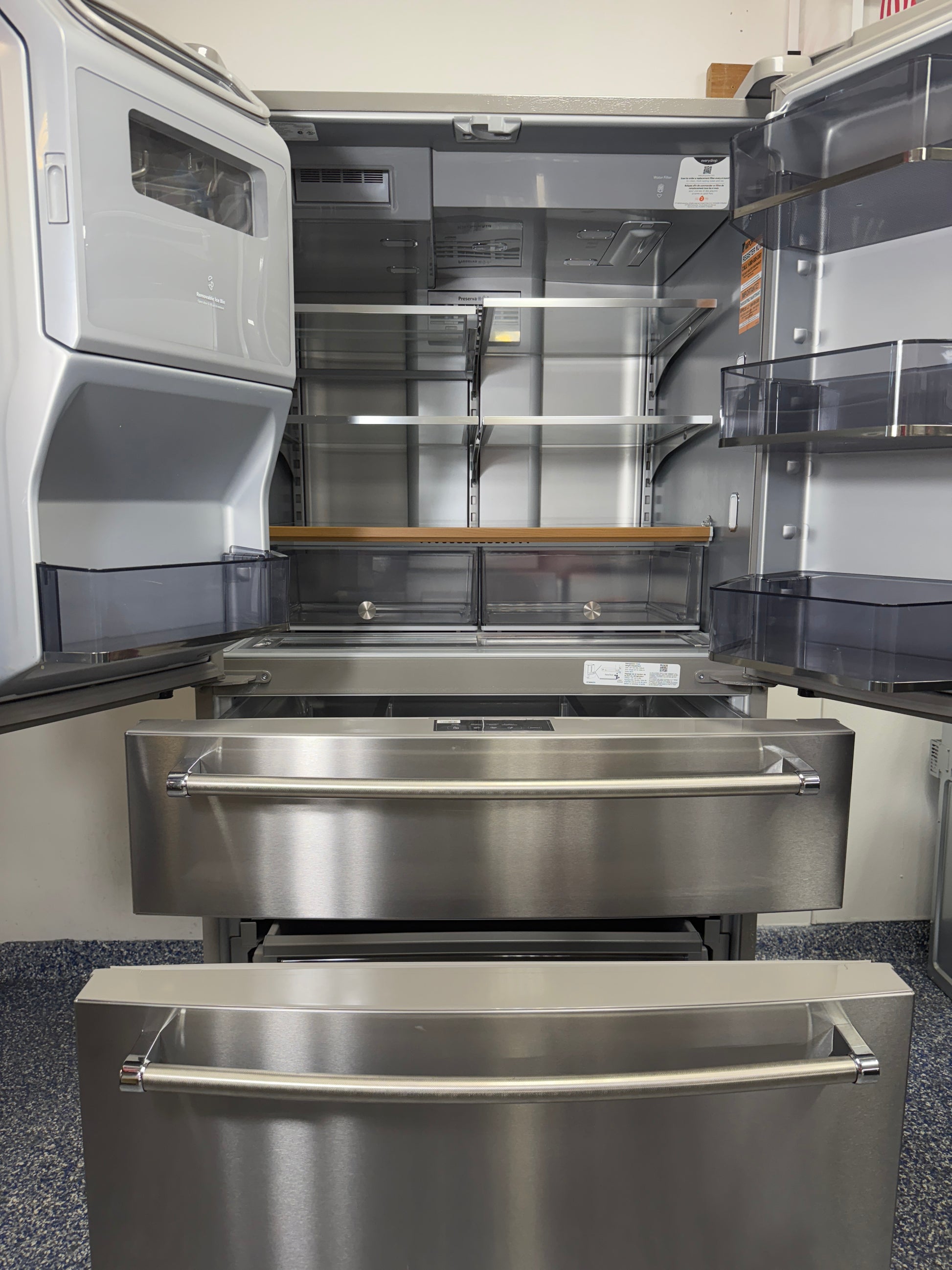 View of the KitchenAid KRMF536RPS refrigerator with all five doors open, showing the spacious interior, shelving, and organizational features. On sale at Appliance Shark - Scratch & Dent store | Kansas City.