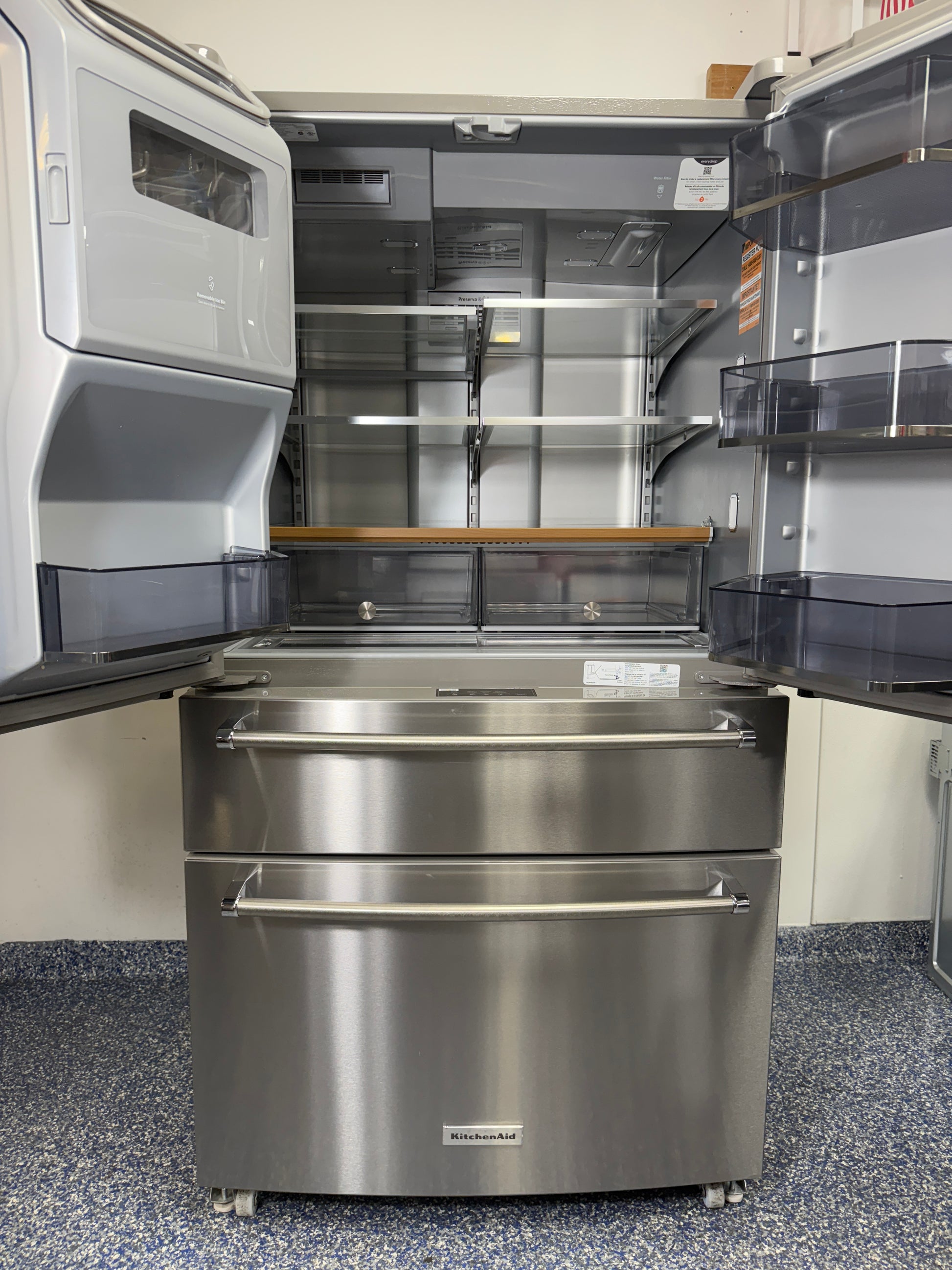 Interior view of the main refrigerator compartment of the KitchenAid KRMF536RPS, highlighting the Preserva Food Care System and adjustable storage. On sale at Appliance Shark - Scratch & Dent store | Kansas City.