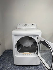 An overhead shot of the LG DLE7150W with the door open, showcasing the extra-large aluminized alloy steel drum. On sale at Appliance Shark - Scratch & Dent store | Kansas City.