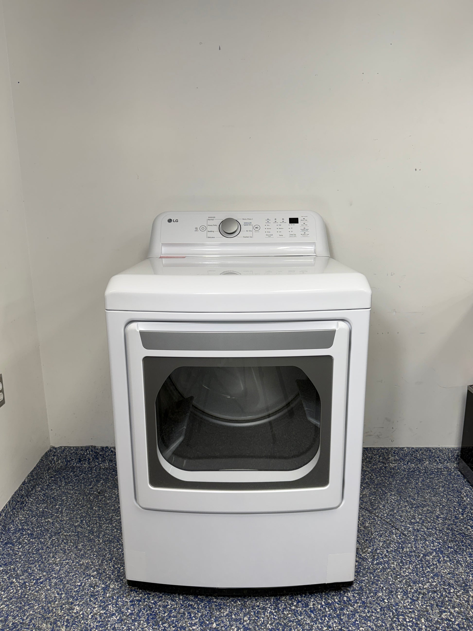 A full frontal image of the LG DLE7150W front-load electric dryer, highlighting its clean white finish and control panel. On sale at Appliance Shark - Scratch & Dent store | Kansas City.