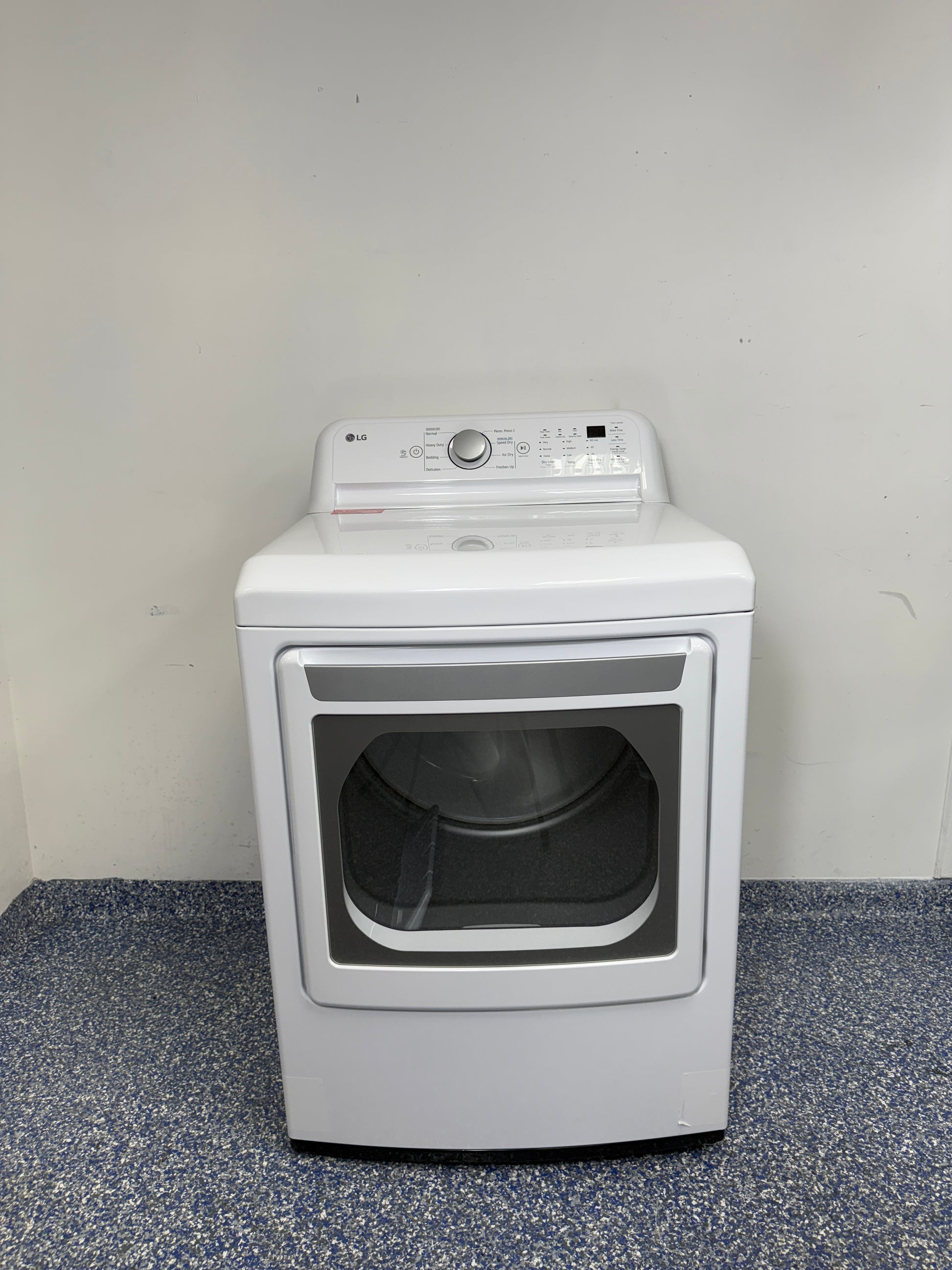 A full frontal image of the LG DLE7150W front-load electric dryer, highlighting its clean white finish and control panel. On sale at Appliance Shark - Scratch & Dent store | Kansas City.