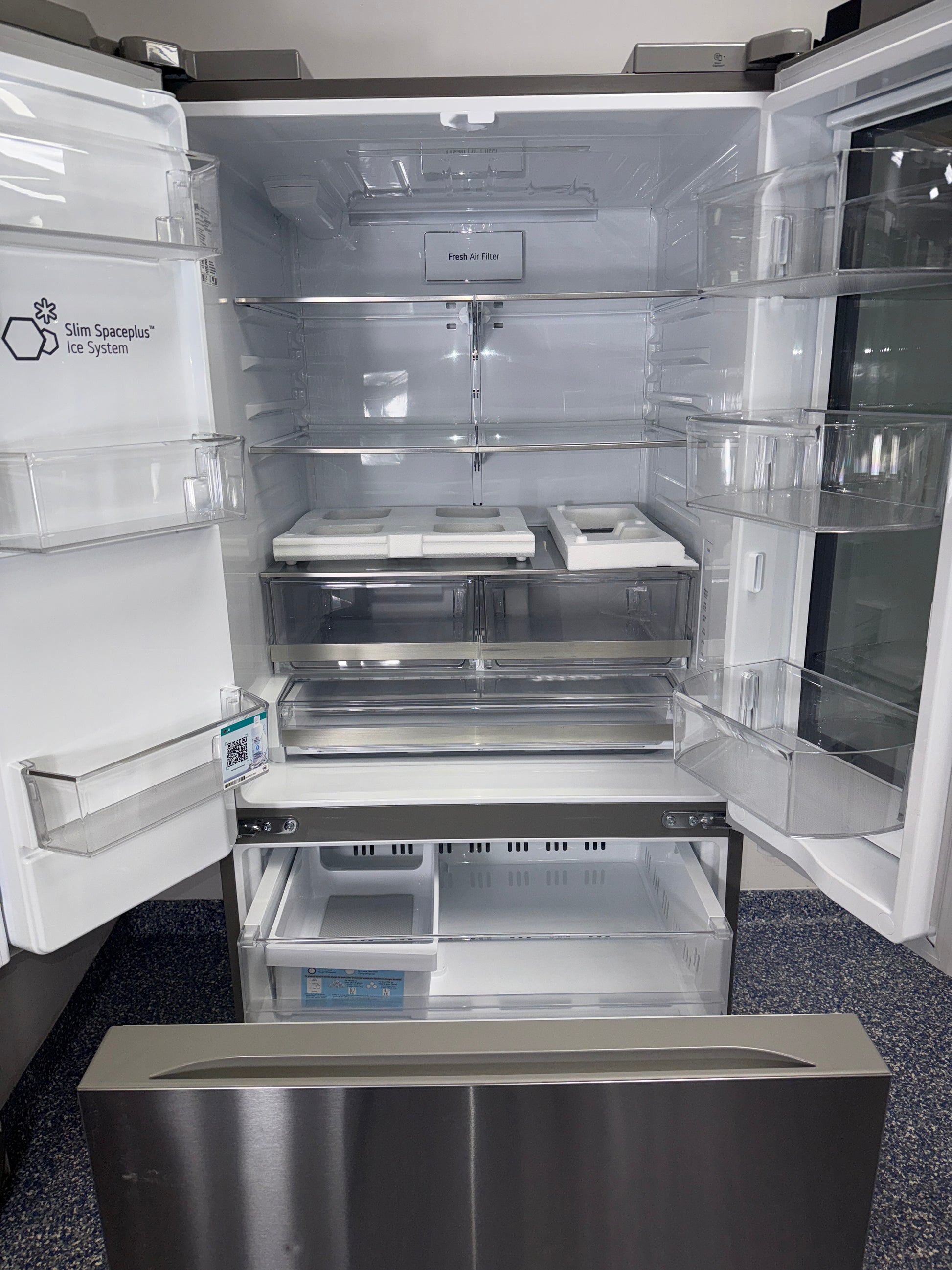 Front view of the LG LF25S6560S 3-door French-door refrigerator in a Kansas City kitchen setting.