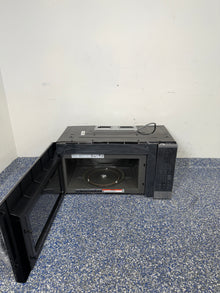 An overhead shot of the LG MVEM1825F with the door open, showcasing the spacious 1.8 cu ft interior. On sale at Appliance Shark - Scratch & Dent store | Kansas City.