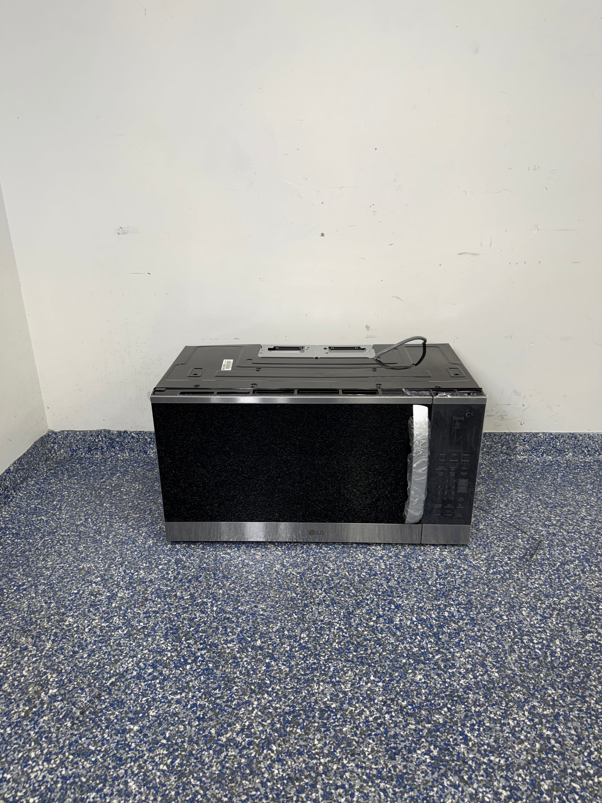 A full frontal image of the LG MVEM1825F over-the-range microwave, highlighting its Stainless Steel finish and sleek design. On sale at Appliance Shark - Scratch & Dent store | Kansas City.