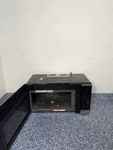 An overhead shot of the LG MVEM1825F with the door open, showcasing the spacious 1.8 cu ft interior. On sale at Appliance Shark - Scratch & Dent store | Kansas City.