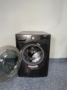 An overhead shot of the LG WM4000HBA with the door open, revealing the large stainless steel drum and Ultra Large Capacity. On sale at Appliance Shark - Scratch & Dent store | Kansas City.