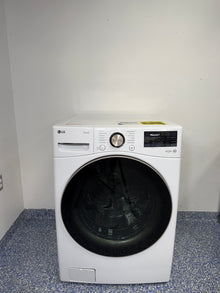 A full frontal image of the LG WM4000HWA front-load stackable washing machine, highlighting its clean white finish and digital control panel. On sale at Appliance Shark - Scratch & Dent store | Kansas City.