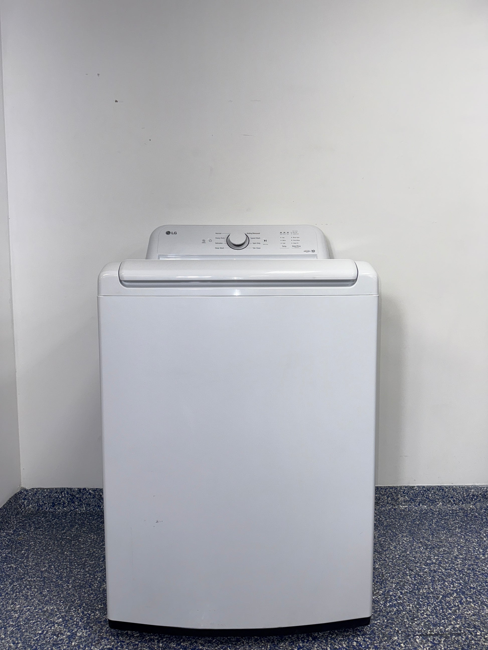 The interior of the LG WT6105CW washer, showcasing its durable stainless steel drum, for sale in Kansas.