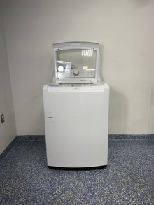 An overhead shot of the LG WT6105CW with the lid open, showcasing the large stainless steel drum and 4-Way Agitator. On sale at Appliance Shark - Scratch & Dent store | Kansas City.