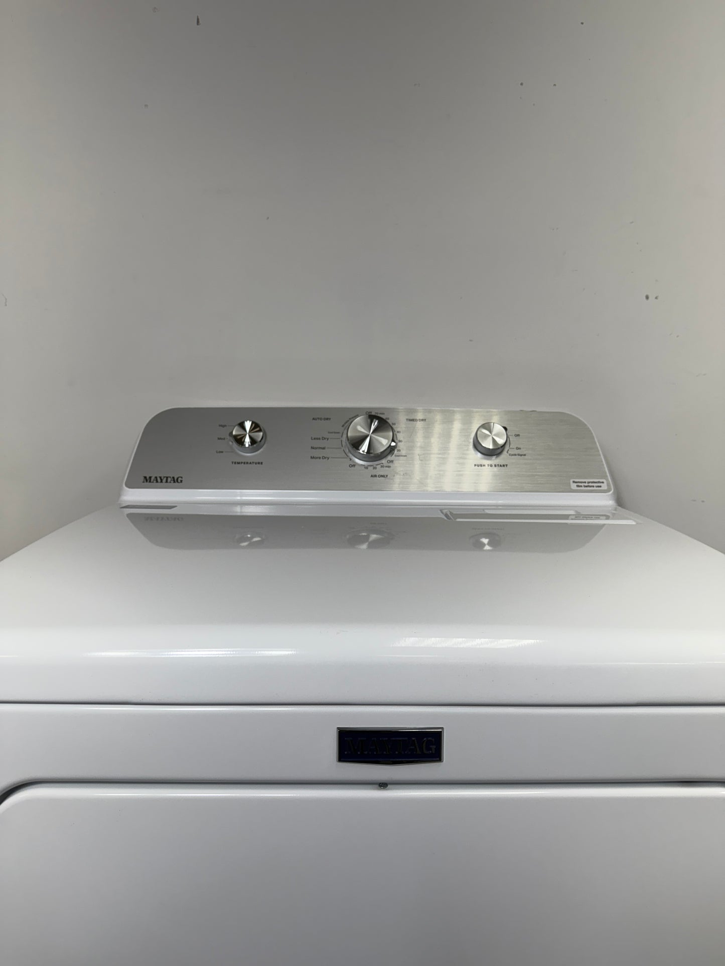 A detailed view of the simple electromechanical control knobs for the MAYTAG MED4500MW, showing the various cycles and temperature settings. On sale at Appliance Shark - Scratch & Dent store | Kansas City.