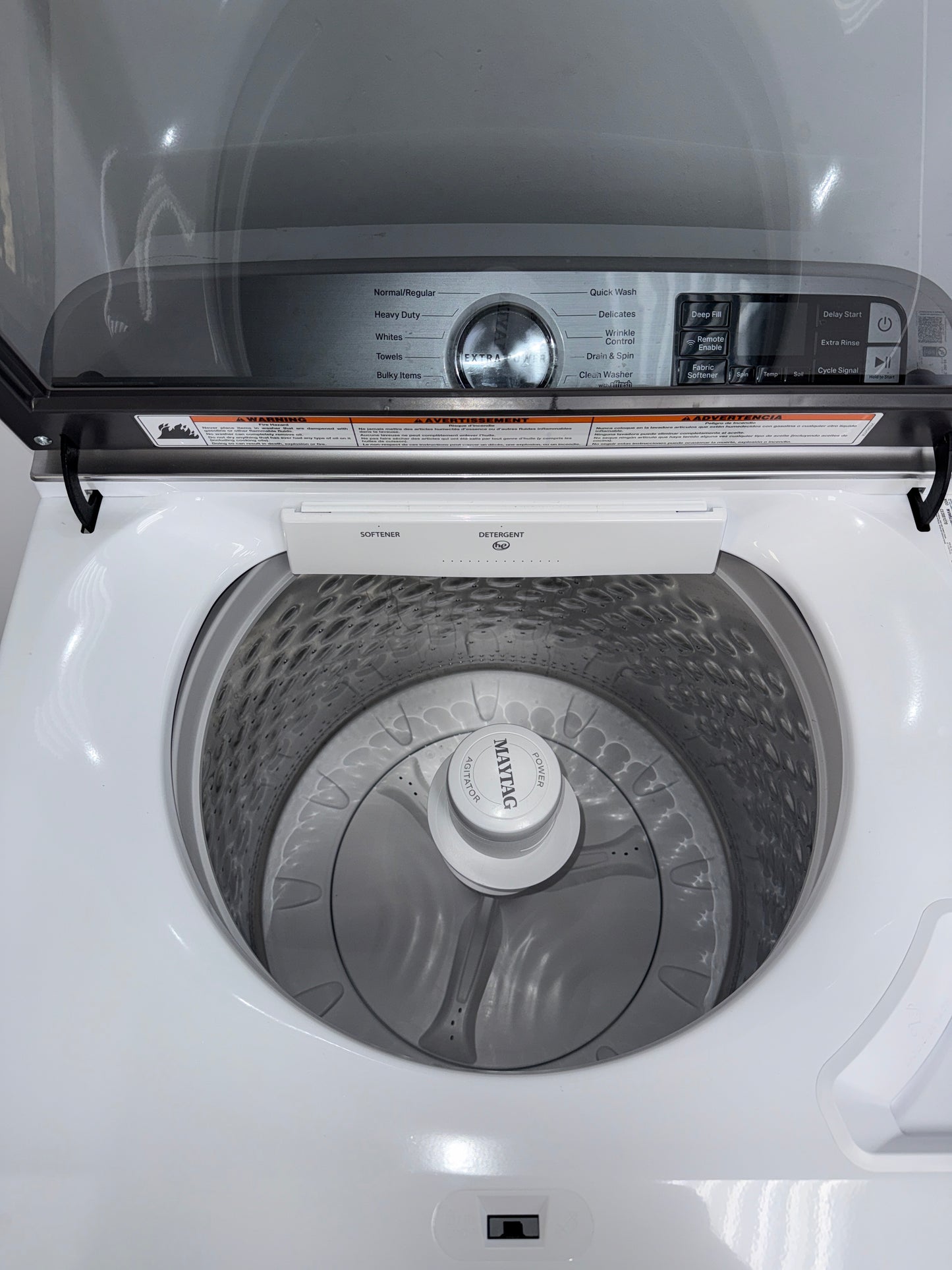 A front view of the MAYTAG MVW6230HW washer, highlighting its built-in water faucet, ready for installation in a Kansas City laundry room.