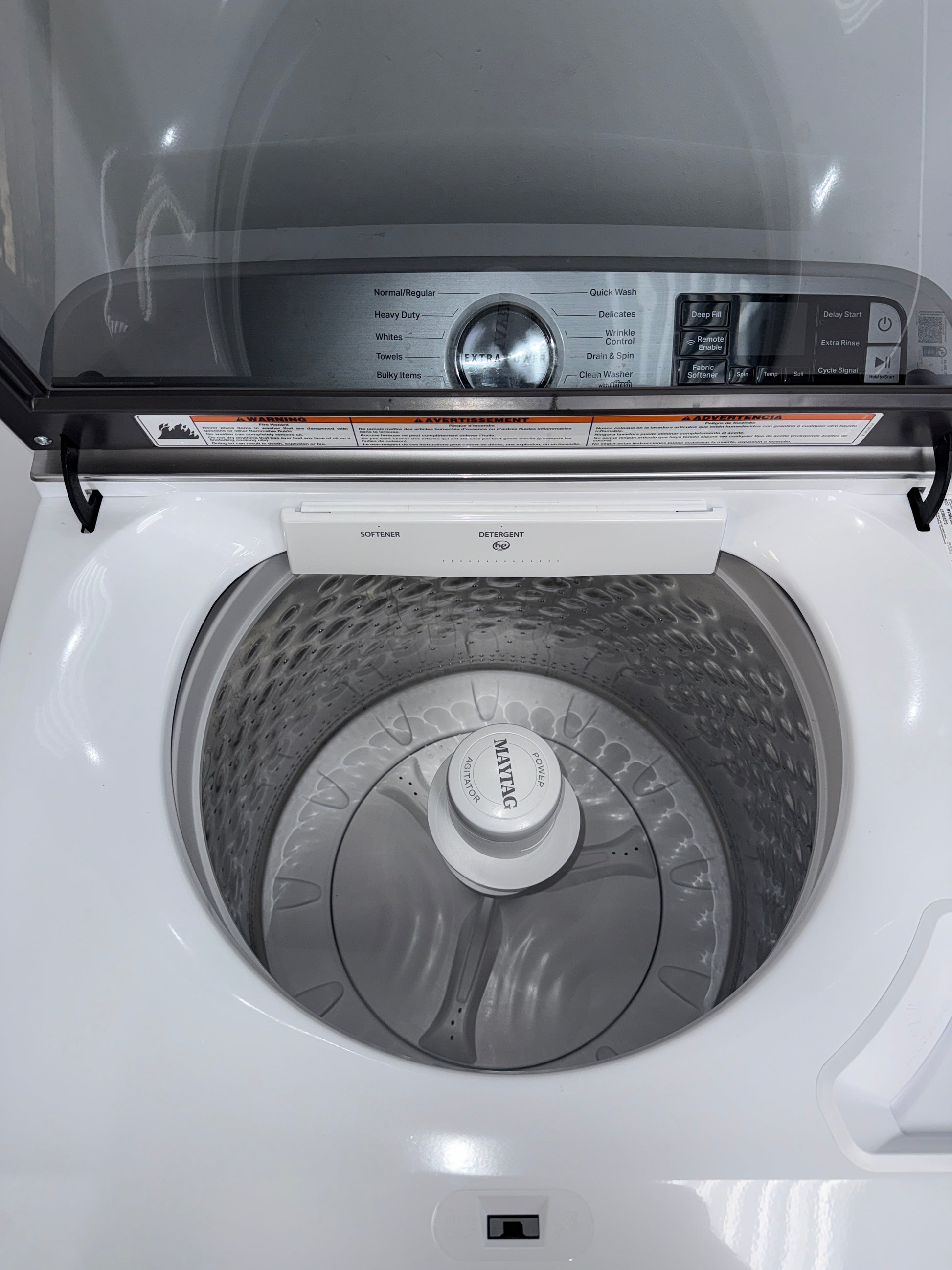 A front view of the MAYTAG MVW6230HW washer, highlighting its built-in water faucet, ready for installation in a Kansas City laundry room.