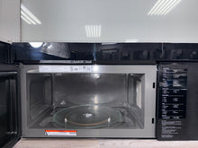 A close-up of the LG MVEL2137F's spacious 2.1 cu. ft. interior, showcasing the easy-clean coating and turntable. A great scratch and dent deal in Overland Park.