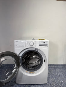 A close-up view of the wash cylinder of the LG WM3400CW washer, highlighting the NeveRust stainless steel and large capacity. This scratch and dent appliance is available at a discount in Kansas City.