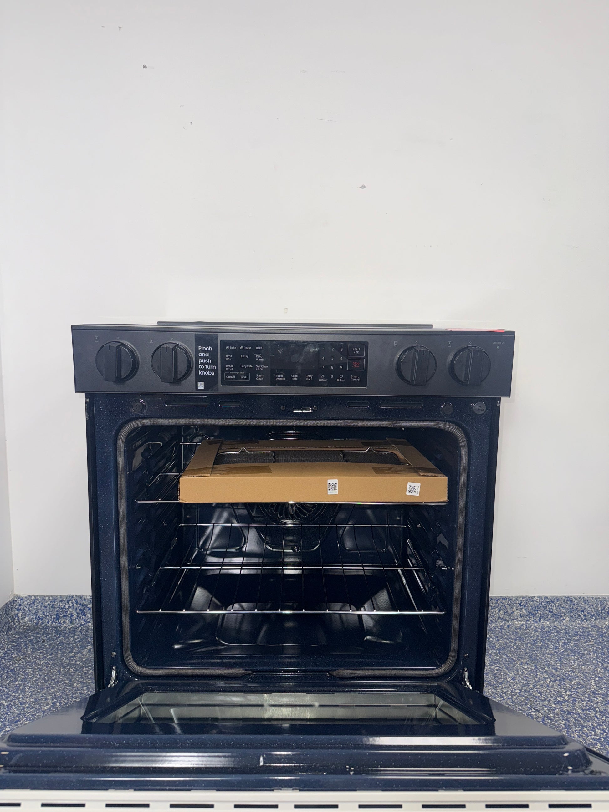 The SAMSUNG 6.3 cu. ft. electric range, model NSE6DB830012, available at Appliance Shark.