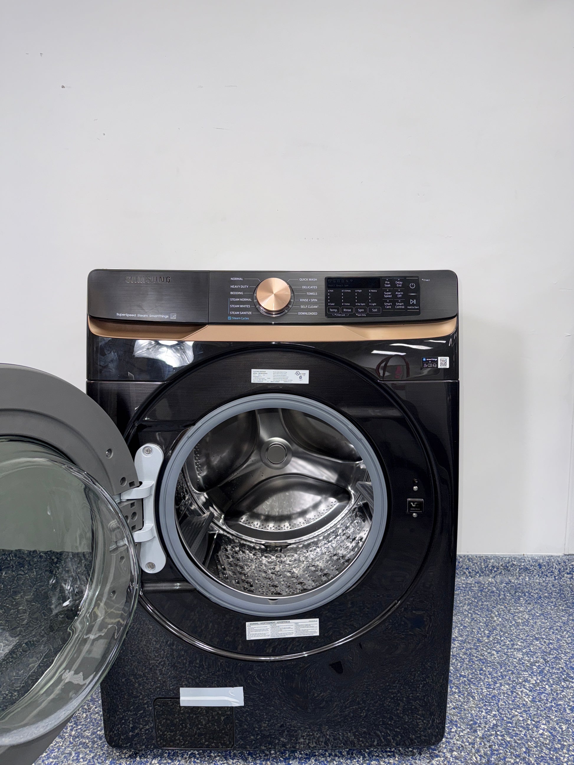 A close-up view of the interior of the SAMSUNG WF50BG8300AVUS washer, showcasing its Self Clean+ feature, an ideal appliance for homes in Overland Park.