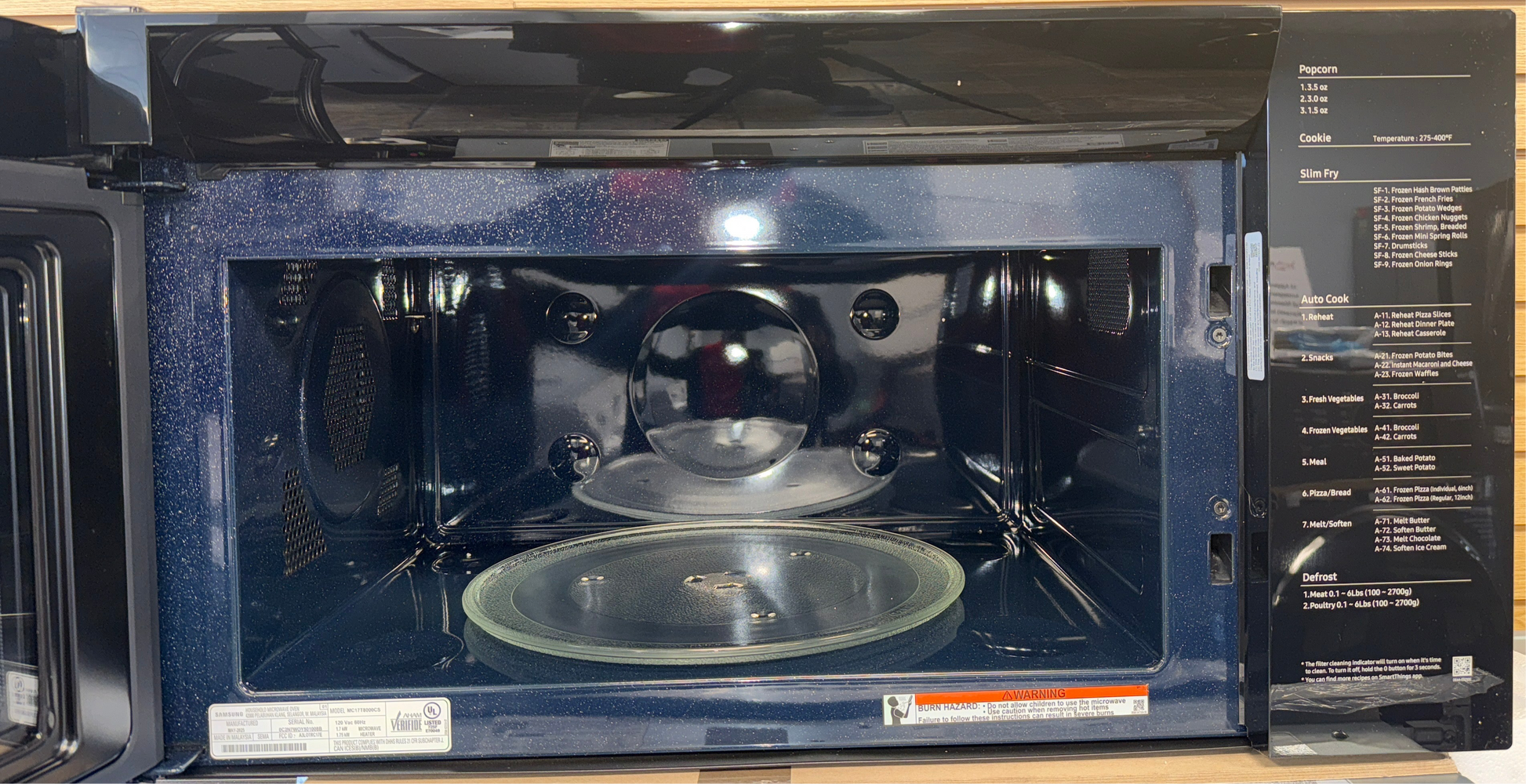 The SAMSUNG over-the-range microwave featuring Slim Fry technology, an ideal appliance for homes in Overland Park.