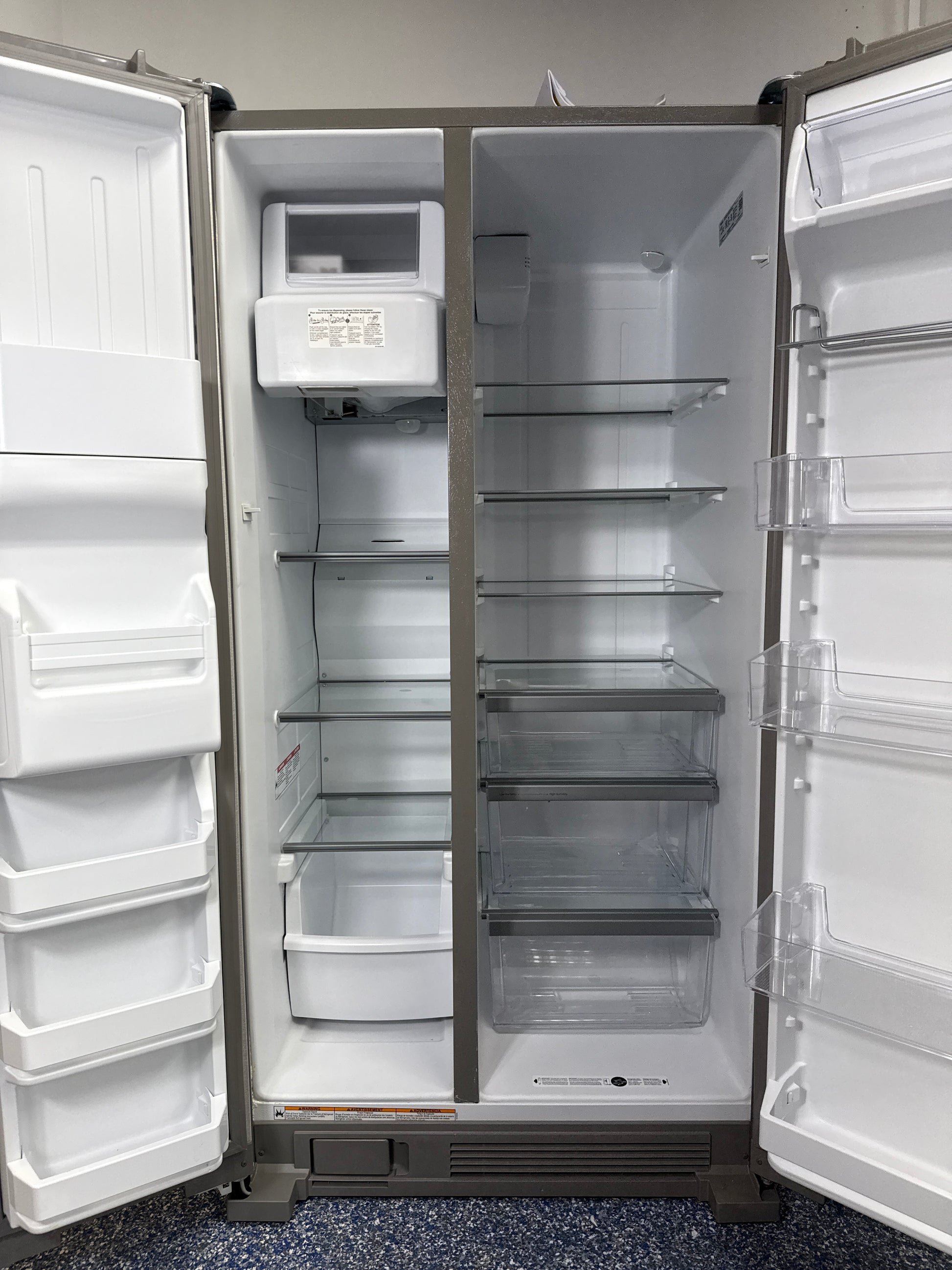 Interior look at the WRS325SDHZ refrigerator, highlighting the spacious In-Door-Ice storage and adjustable gallon door bins.
