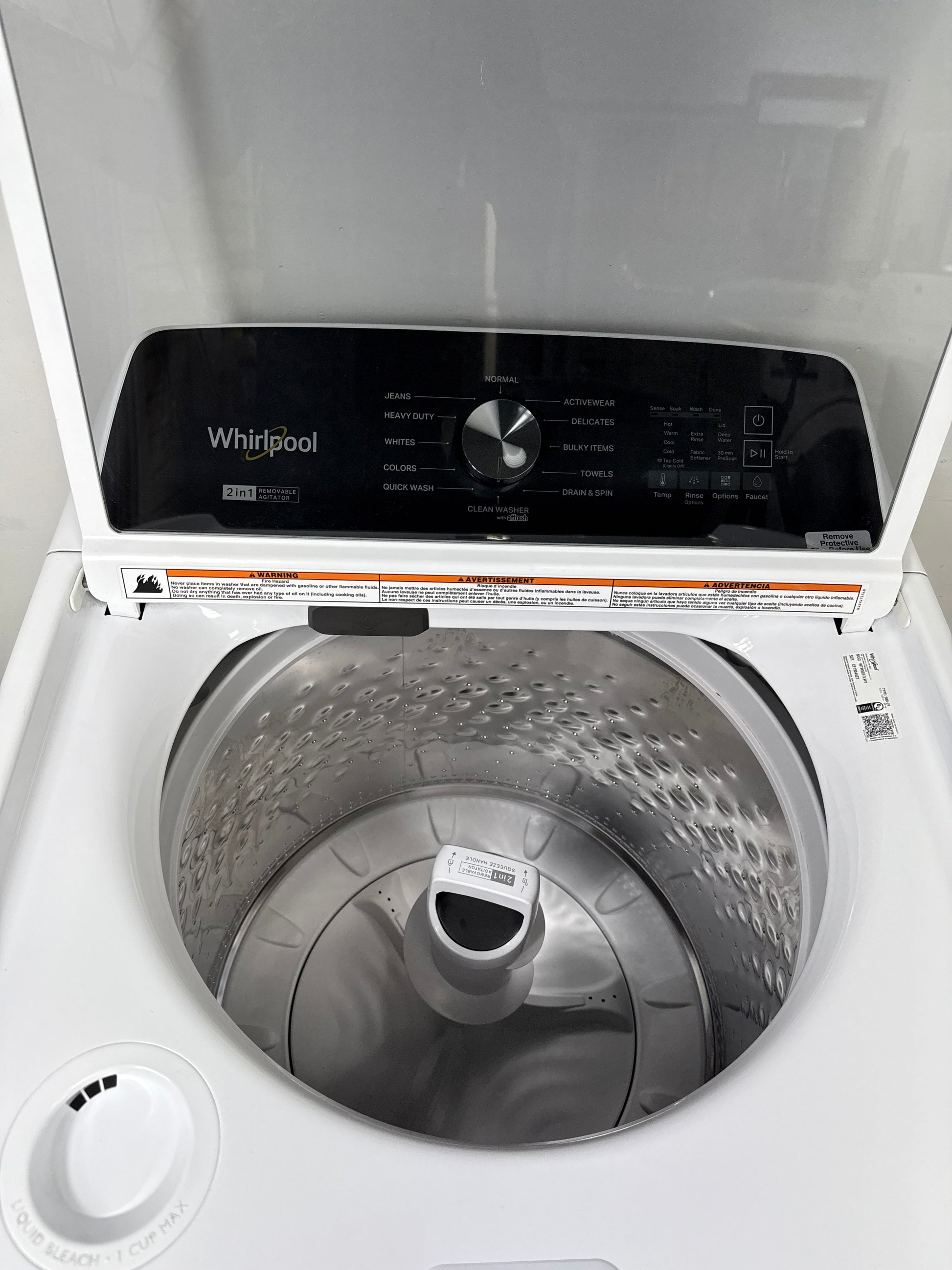 A close-up view of the interior of the WTW5057LW washer, highlighting the durable porcelain tub and built-in Pretreat Station. This scratch & dent deal is available in Kansas City.