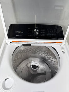 A close-up view of the interior of the WTW5057LW washer, highlighting the durable porcelain tub and built-in Pretreat Station. This scratch & dent deal is available in Kansas City.