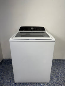 A full frontal photo of the WHIRLPOOL WTW5057LW top-load washing machine, showcasing its clean white finish and knob controls. Find this scratch & dent discount at our Kansas City store.