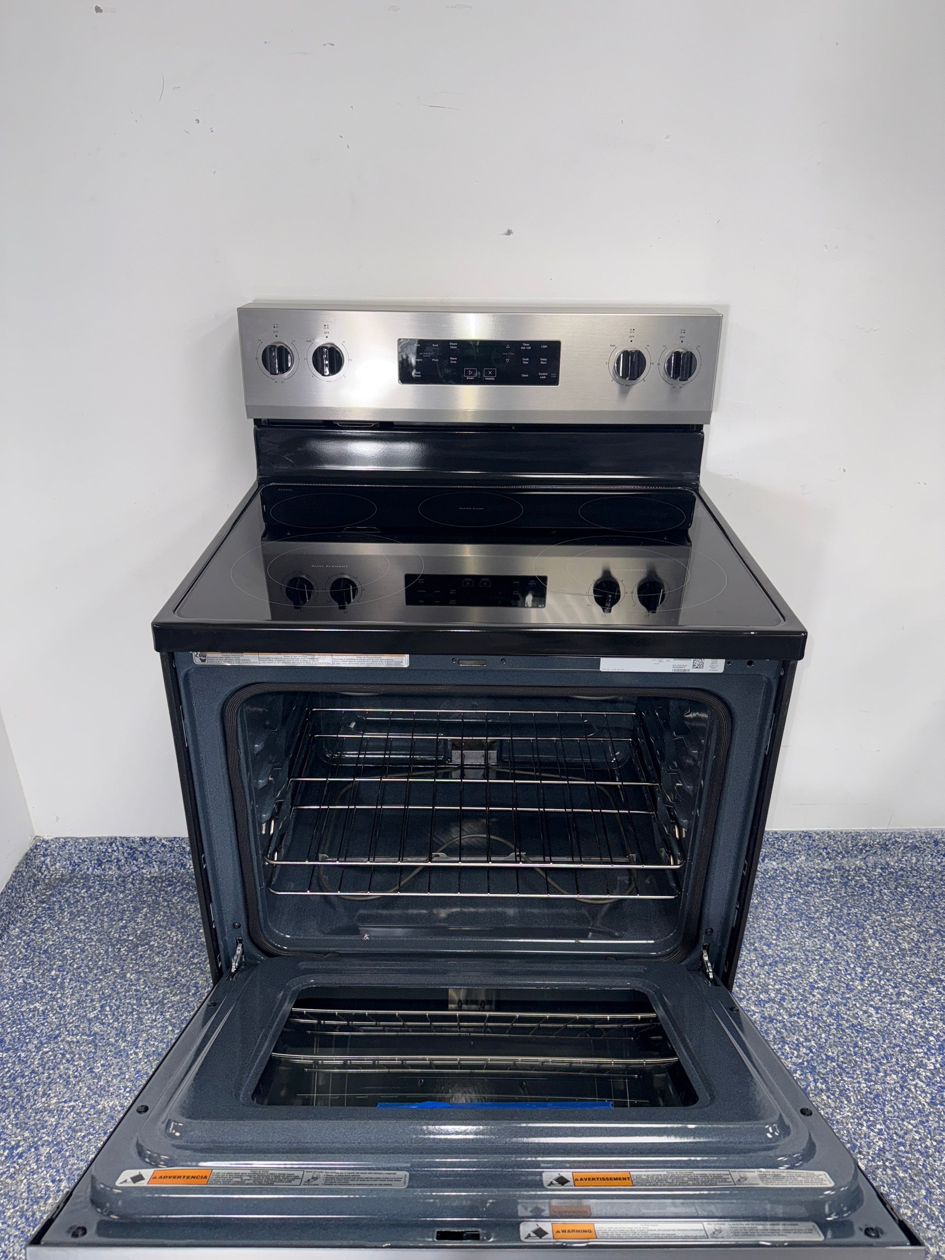 Smooth glass cooktop of the WHIRLPOOL WFES3330RZ2 electric range in the Kansas City area.