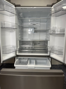 View of the Whirlpool WRFF3136SZ refrigerator with both French doors and the pull-out freezer drawer open, showcasing the full storage space. On sale at Appliance Shark - Scratch & Dent store | Kansas City.