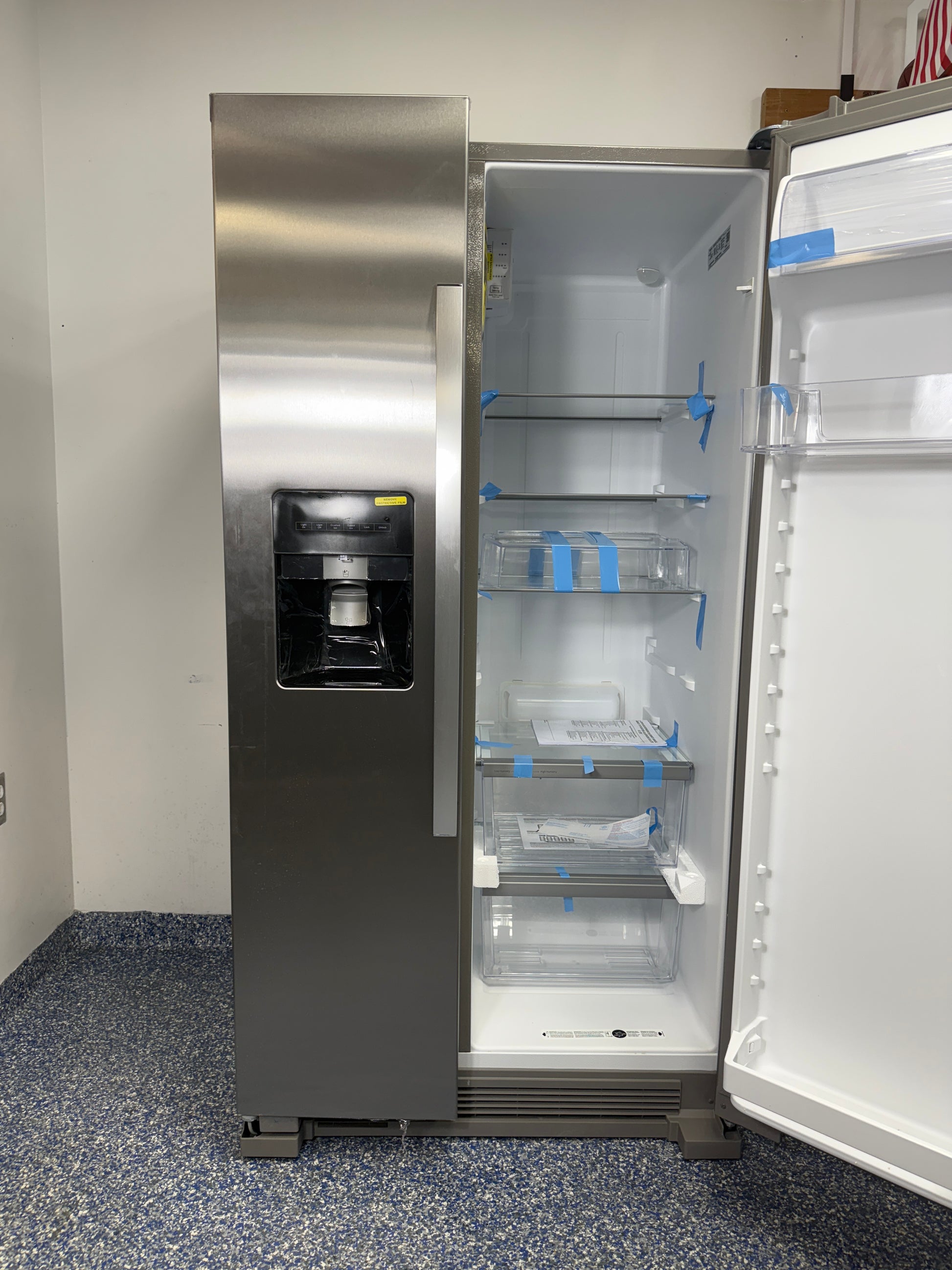 A view of the interior of the Whirlpool WRS315SDHZ refrigerator, highlighting the interior LED lighting and glass shelves. On sale at Appliance Shark - Scratch & Dent store | Kansas City.