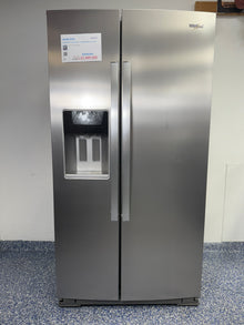 A full frontal image of the WHIRLPOOL WRSC5536RZ side-by-side refrigerator, highlighting its Stainless Steel finish and exterior ice and water dispenser. On sale at Appliance Shark - Scratch &amp; Dent store | Kansas City.