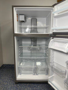 A close-up of the interior of the WRT311FZDZ05 refrigerator, highlighting the Flexi-Slide™ Bin and Frameless Glass Shelves. On sale at Appliance Shark - Scratch & Dent store | Kansas City.