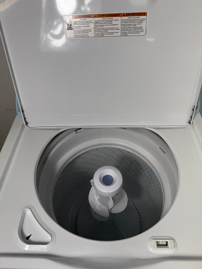 A close-up view of the interior of the Whirlpool WTW4816FW washer, highlighting the durable porcelain tub and dual-action agitator. On sale at Appliance Shark - Scratch & Dent store | Kansas City.