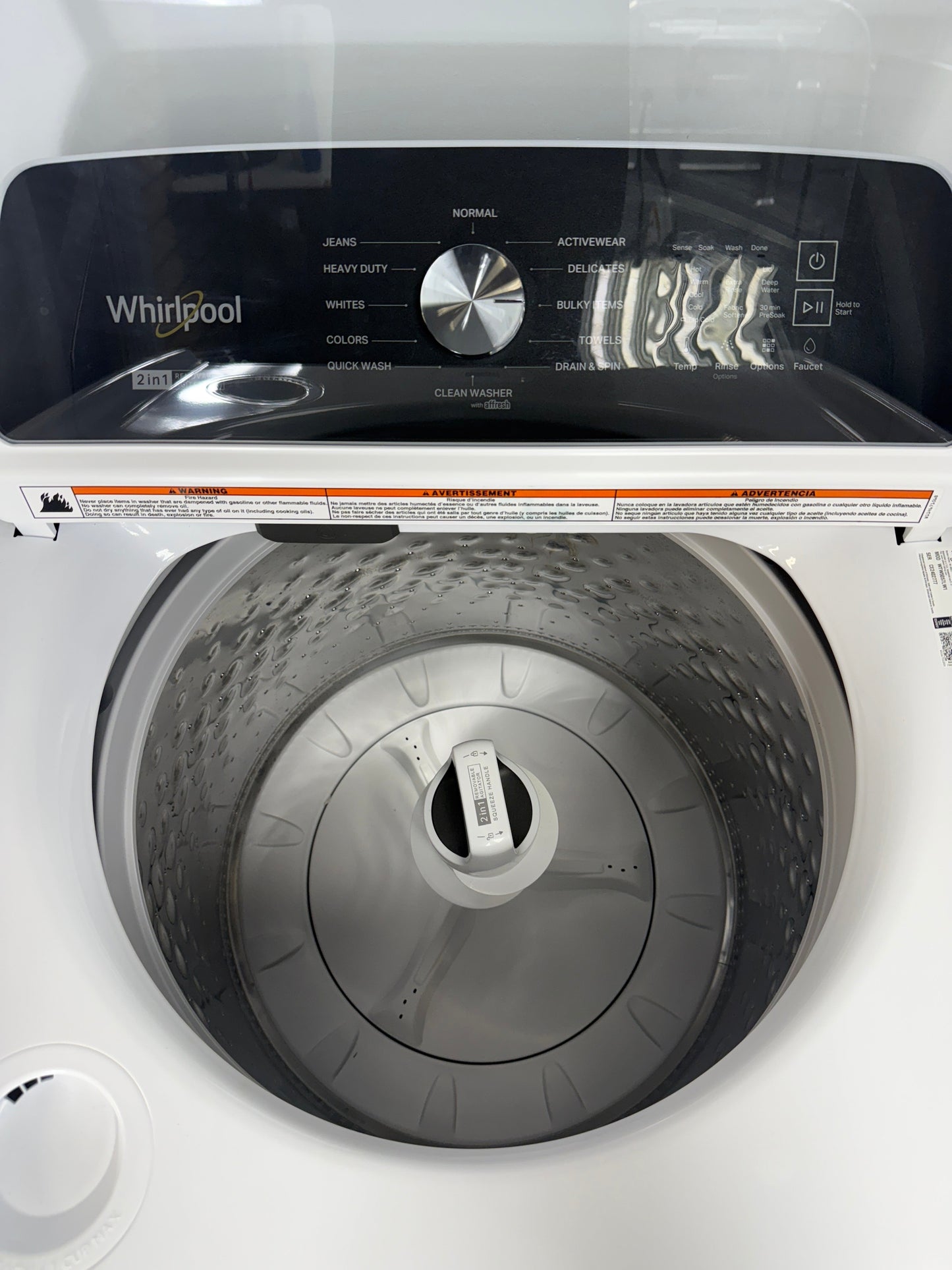 A front view of the WHIRLPOOL WTW5057LW washer, highlighting its Clean Washer with affresh® Cycle, ready for installation in a Kansas City laundry room.