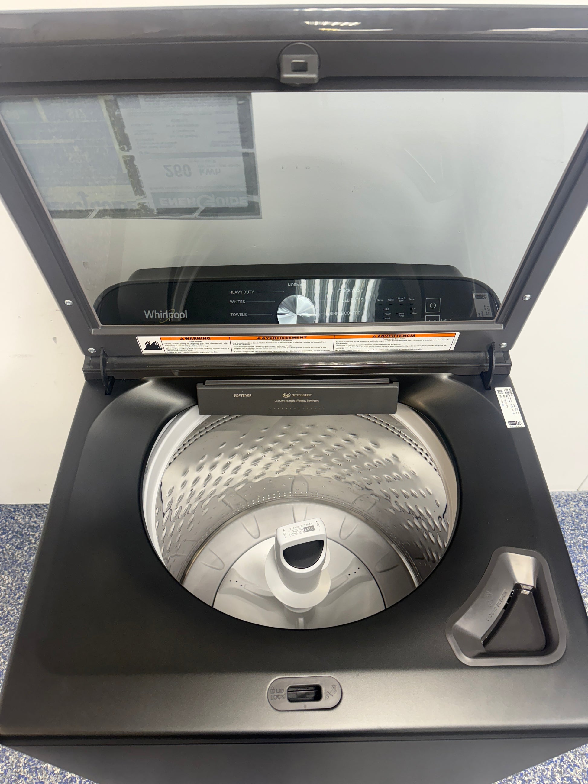 Open-lid view showing the large stainless-steel drum of the WHIRLPOOL WTW6157PB1, featured in Kansas City homes.