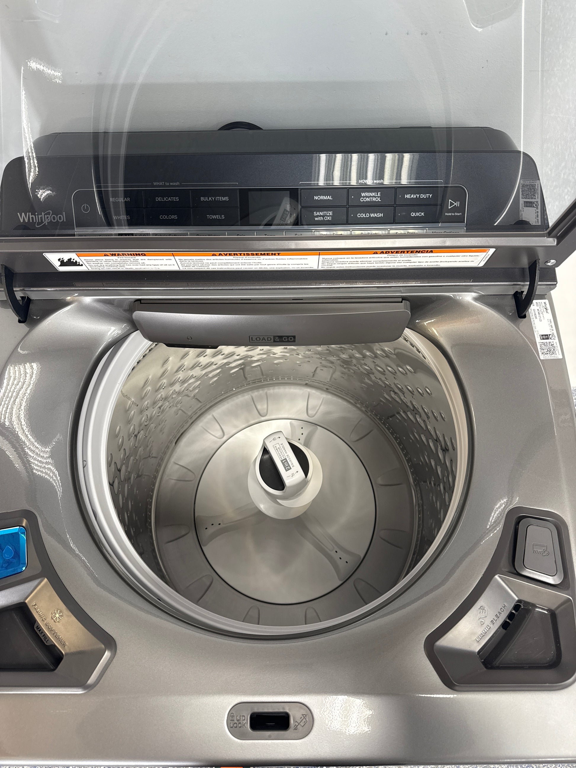 Open lid and interior tub of the WHIRLPOOL WTW8127LC3 top load washer in Overland Park, KS.
